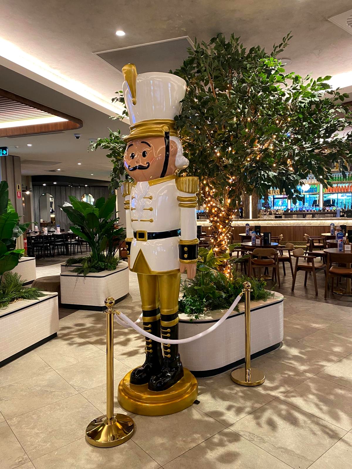Life-size nutcracker Christmas display in a club lounge and dining area