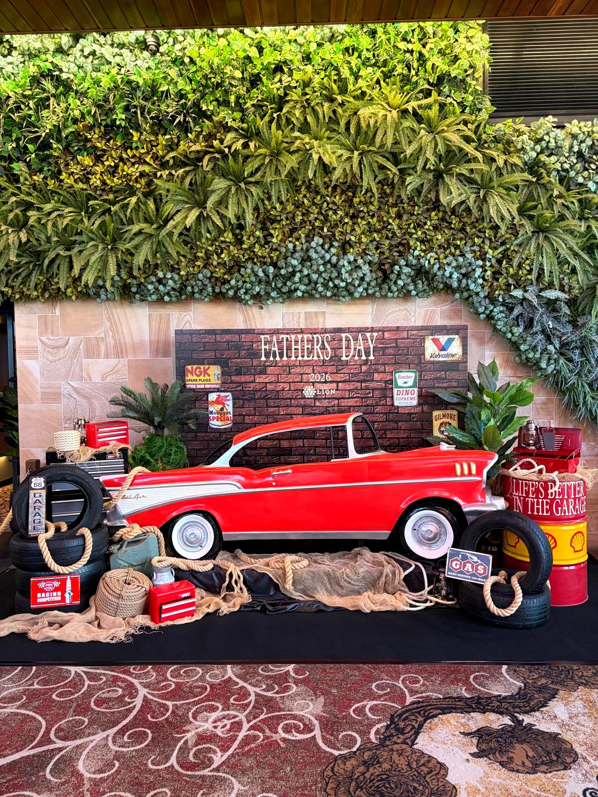 Classic red Chevy car Father's Day display with garage props at The Lion