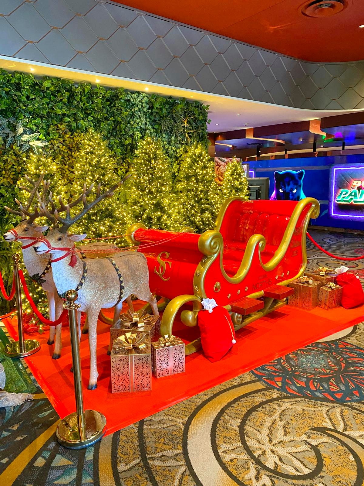 Red and gold Christmas sleigh and reindeer display at Norths