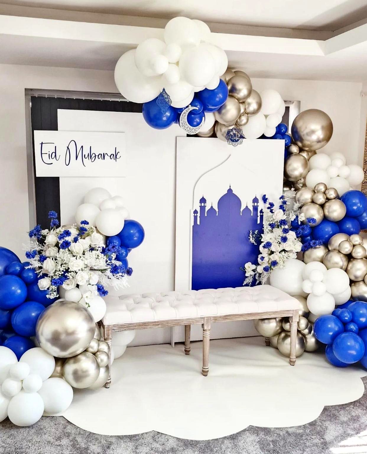 Eid Mubarak blue and white balloon installation with mosque silhouette backdrop