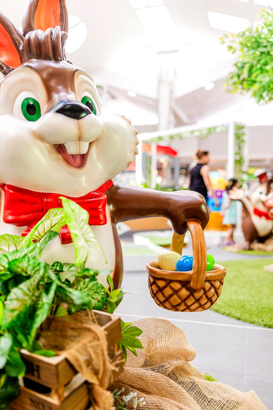 Easter bunny character prop holding a basket of eggs