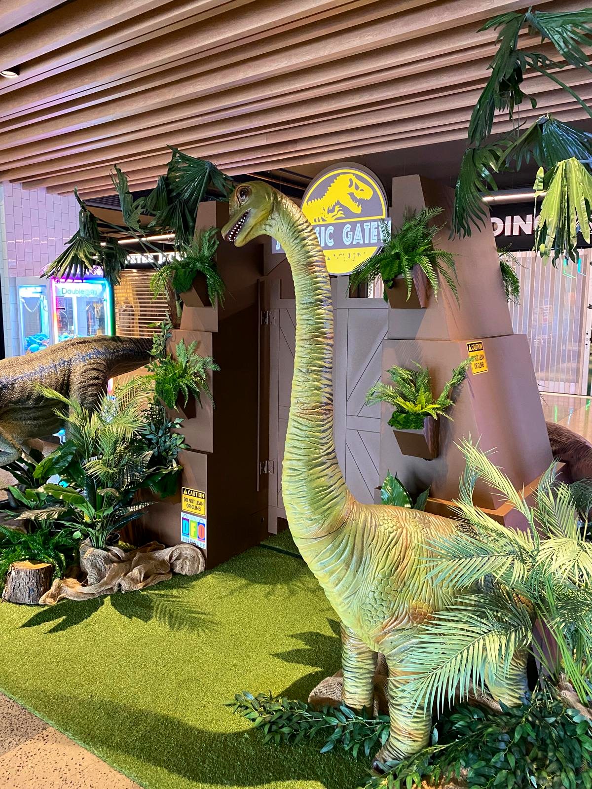 Life-size brachiosaurus dinosaur display at Jurassic Gateway activation