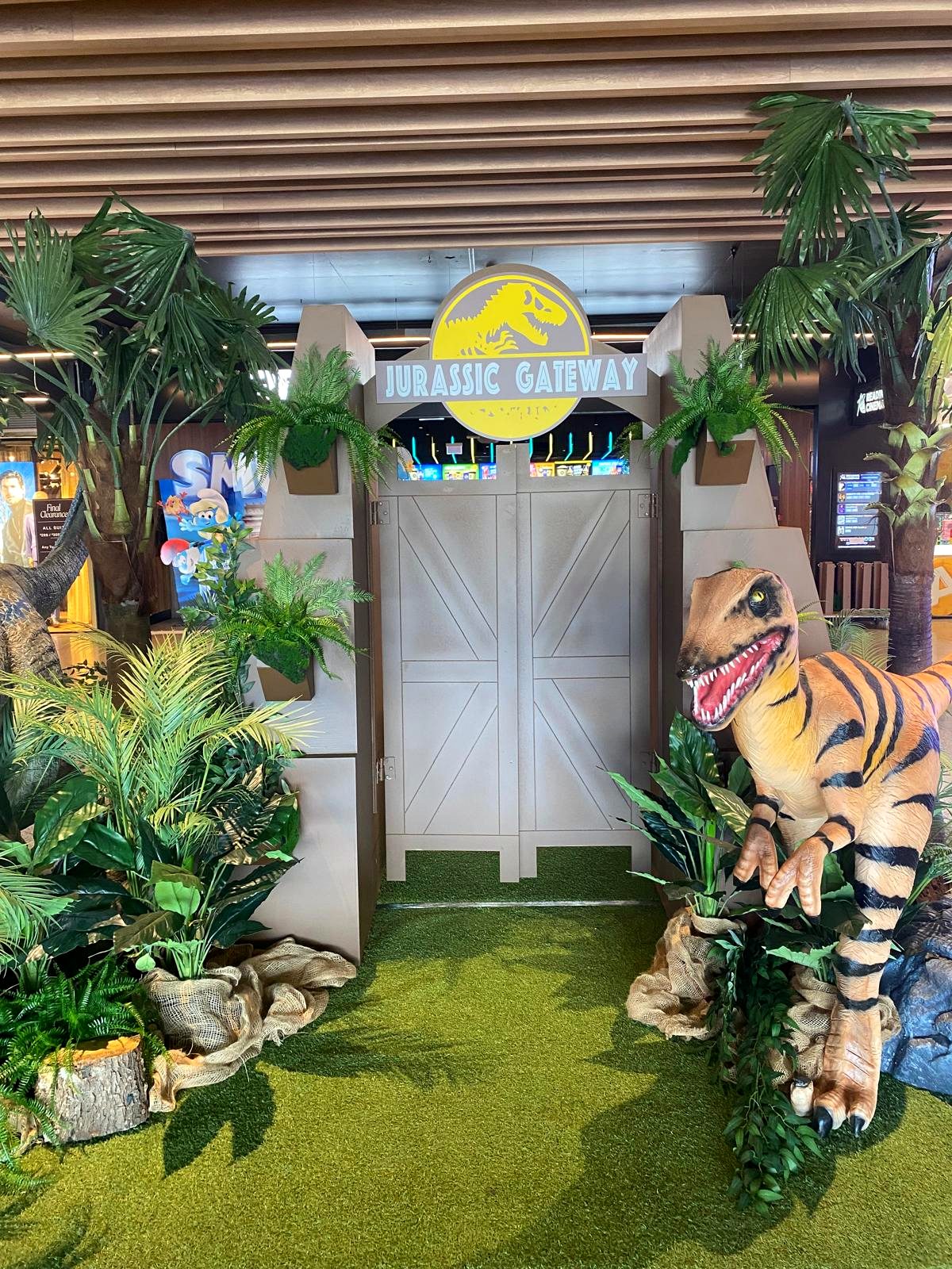 Life-size raptor dinosaur display at Jurassic Gateway activation
