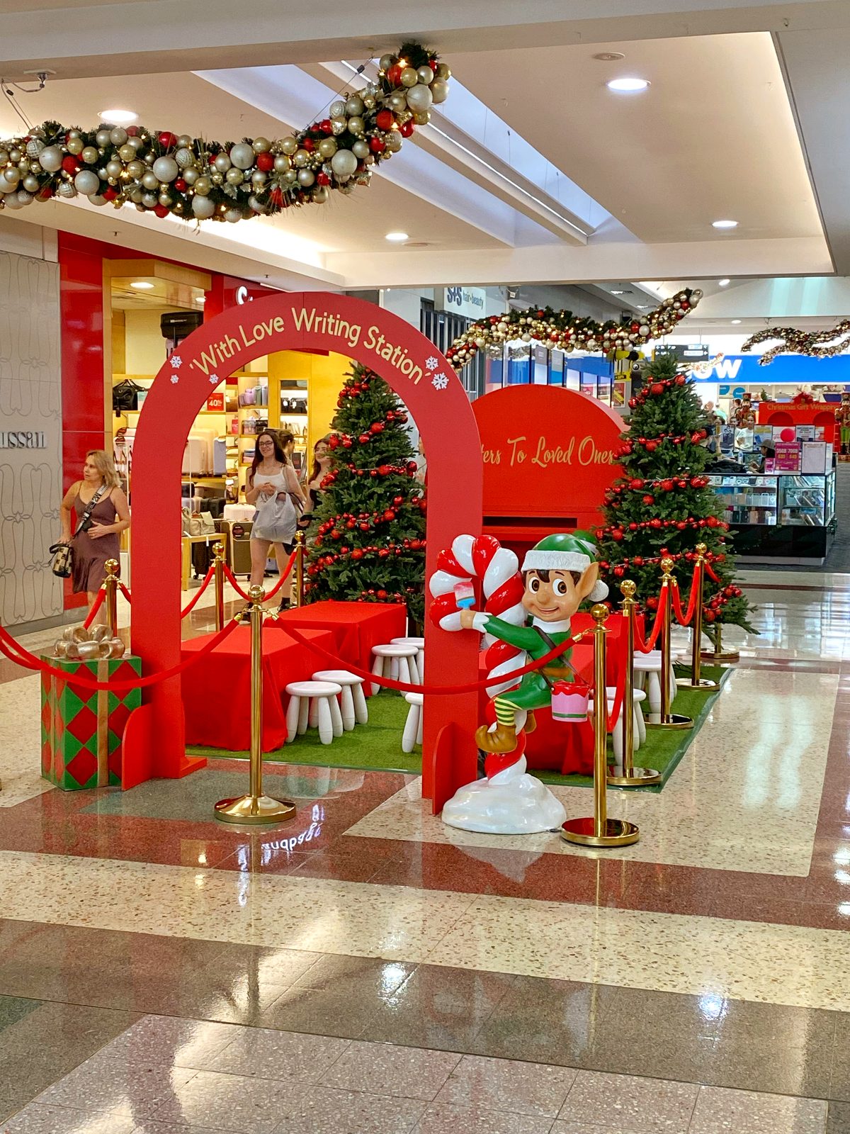 With Love Writing Station Christmas activation with elf and candy cane props