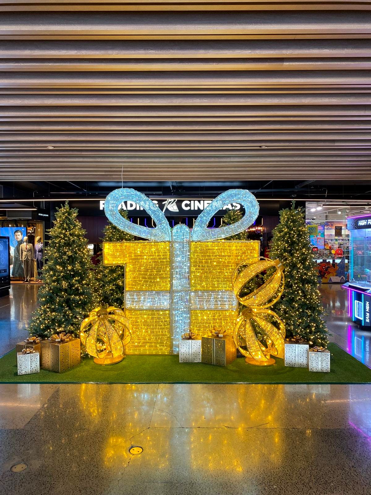 Illuminated giant Christmas gift box display outside a cinema