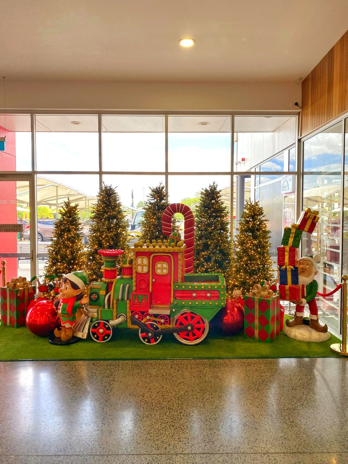Christmas train display with elf characters and candy cane