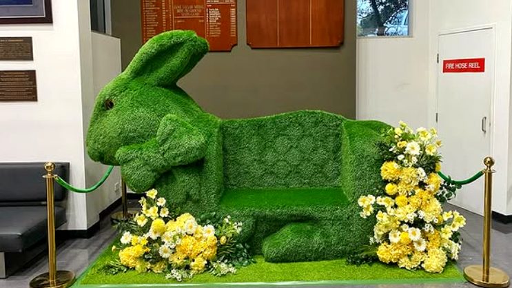 Giant topiary Easter bunny bench display