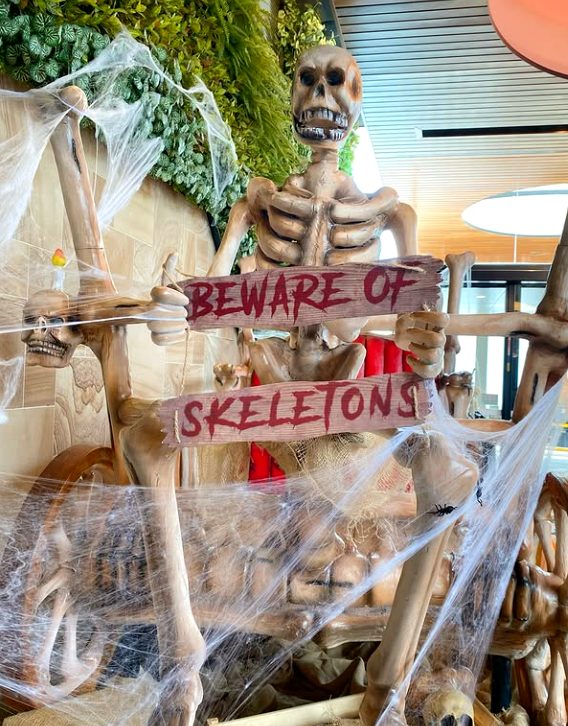 Beware of Skeletons Halloween display with cobwebs