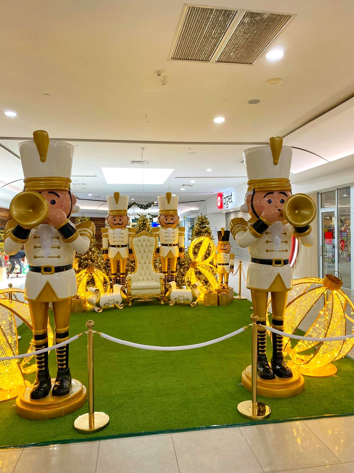 Life-size nutcracker soldiers playing trumpets Christmas display in a shopping centre